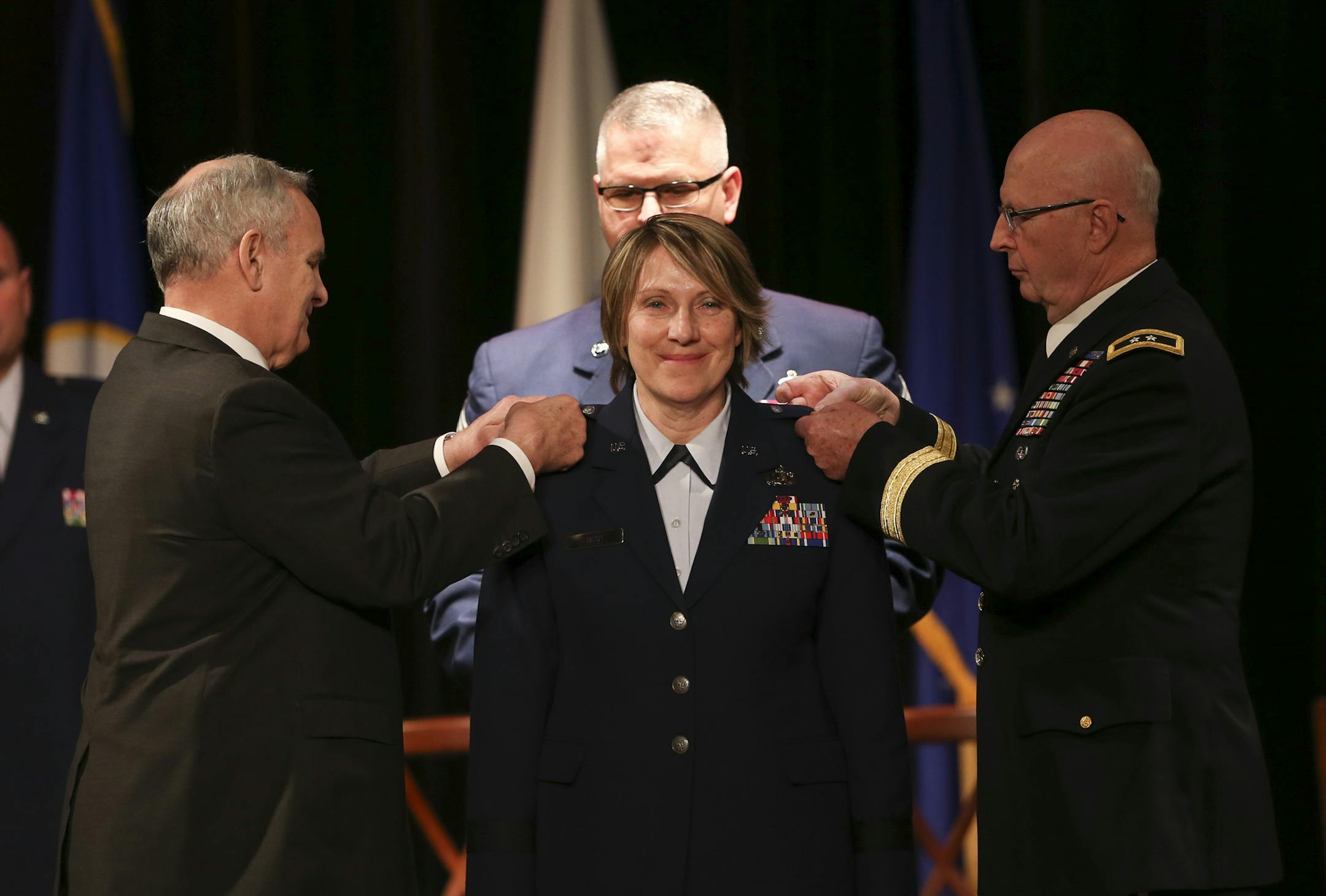 Minnesota Gov. Mark Dayton, left, and Maj. Gen. Richard Nash of the Minnesota National Guard each pinned a general's star on the shoulders of Col. Sandy Best at the promotion ceremony where she became Brigadier General Best Thursday afternoon. ] JEFF WHEELER ï jeff.wheeler@startribune.com Col. Sandy Best became the first female general in Minnesota National Guard history she was promoted to brigadier general in a formal promotion ceremony Thursday afternoon, February 25, 2016 at The Woman's