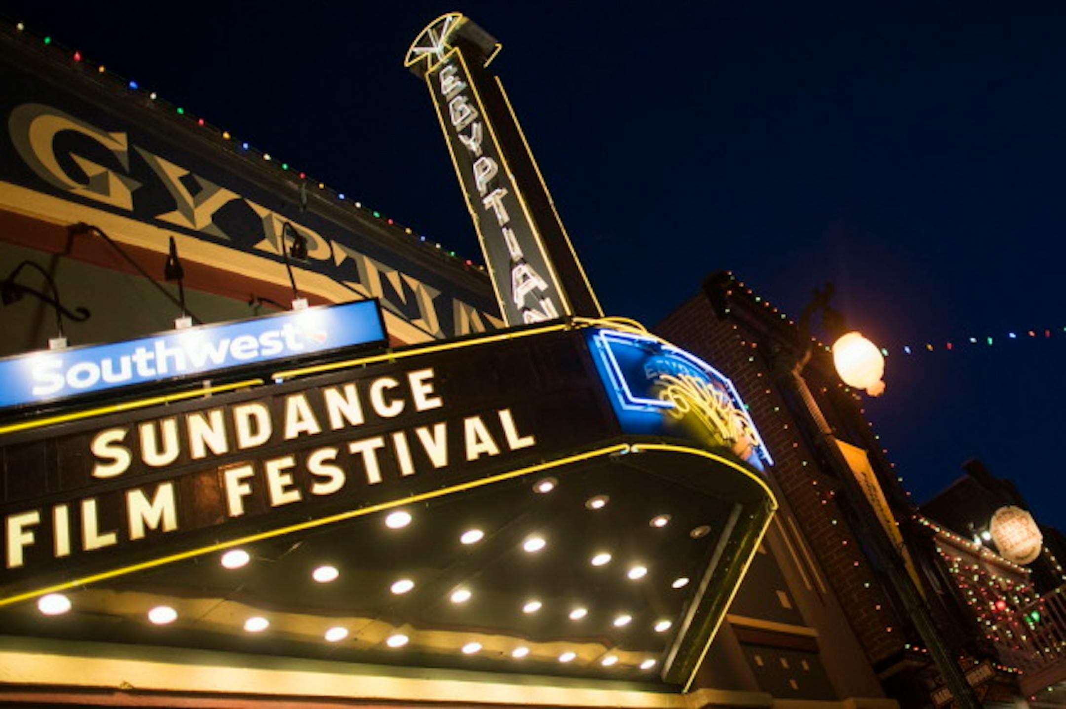FILE - This Jan. 22, 2015 file photo shows the Egyptian Theatre on Main Street during the first day of  the 2015 Sundance Film Festival in Park City, Utah. Every January, the streets of the mountain town of Park City, Utah, light up as the Robert Redford-founded Sundance Film Festival pulls in big names to introduce future Oscar winners and eye-opening documentaries. Tickets for many screenings during the festival that starts Jan. 21, 2016, are publicly available, and there are ways to get in on the action and still have some cash left over for popcorn. (Photo by Arthur Mola/Invision/AP, File)
