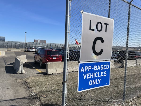 Rideshare drivers wait in a remote lot at Minneapolis-St. Paul International Airport last week. Uber and Lyft plan to leave the Twin Cities market aft