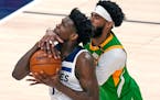 Utah Jazz guard Mike Conley, right, defends against Minnesota Timberwolves forward Anthony Edwards, left, in the first half during an NBA basketball g