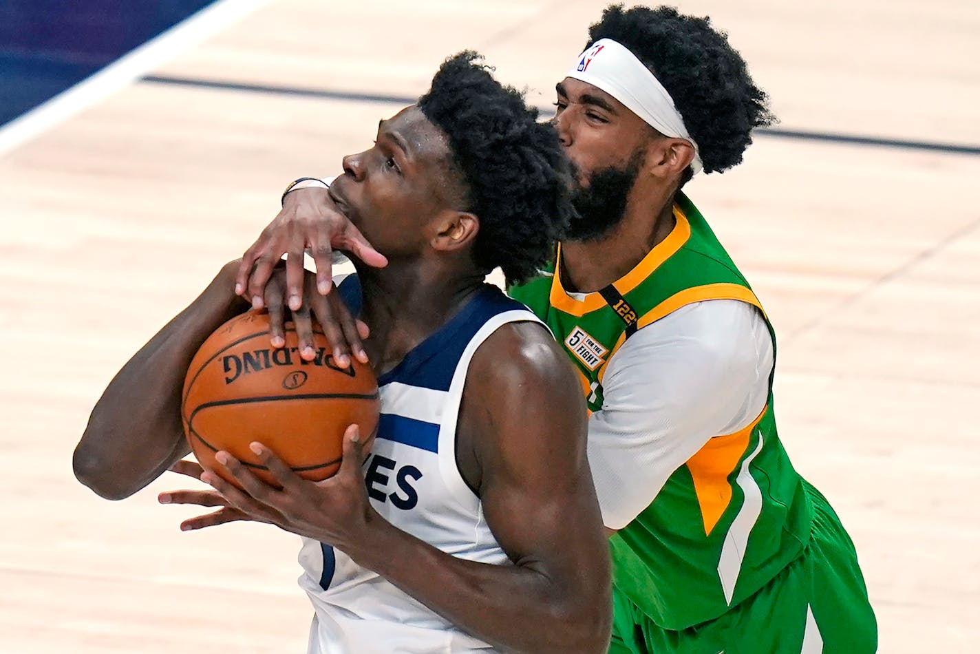 Utah Jazz guard Mike Conley, right, defends against Minnesota Timberwolves forward Anthony Edwards, left, in the first half during an NBA basketball game Saturday, April 24, 2021, in Salt Lake City. (AP Photo/Rick Bowmer)