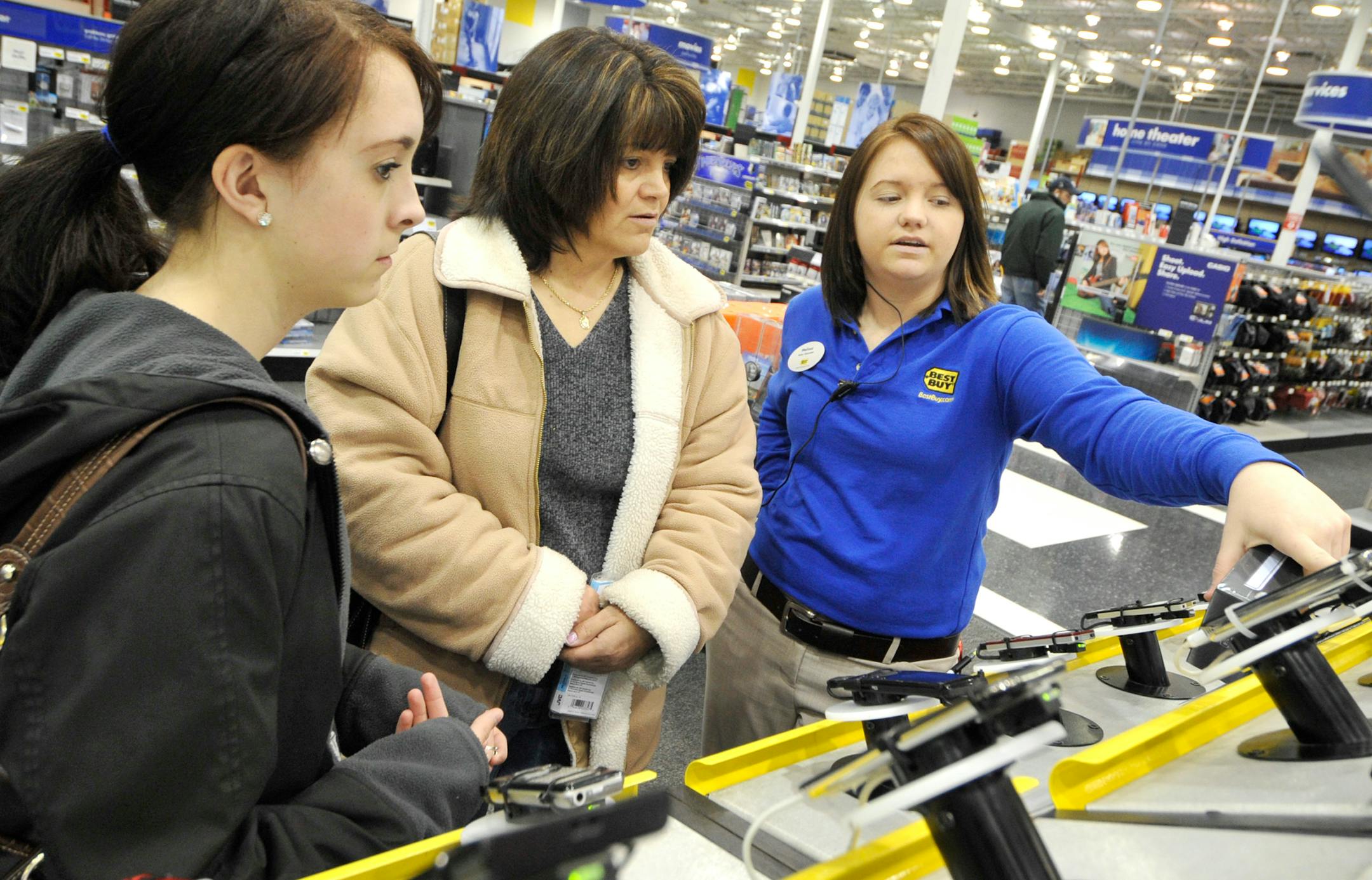 Melissa Douglas helped Paige and Karla Olson pick out an iPod for Paige's 17th birthday at the Best Buy in Apple Valley. Best Buy CEO Brad Anderson said he wants all the retailer's stores to carry products that fit the customers in an individual store's particular neighborhood.