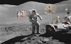FILE &#xf3; In a NASA photo, Eugene Cernan, the commander of Apollo 17, walks towards a lunar rover at the mission's landing site in the Taurus-Littro