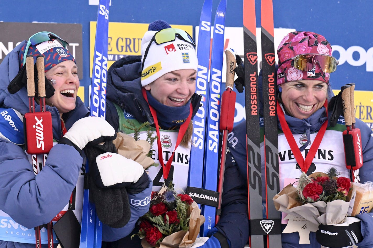 Sweden's Moa Ilar, center, winner of a cross-country ski women's 20 km mass start freestyle competition, celebrates on the podium with second-placed United States' Jessie Diggins