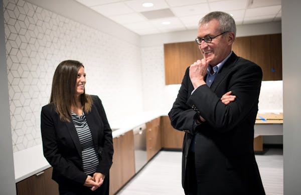 Dennis O'Malley, managing partner at Lindquist & Vennum LLP, and Chief Administrative Officer Dawn Costa shared a laugh in one of the new office's kit