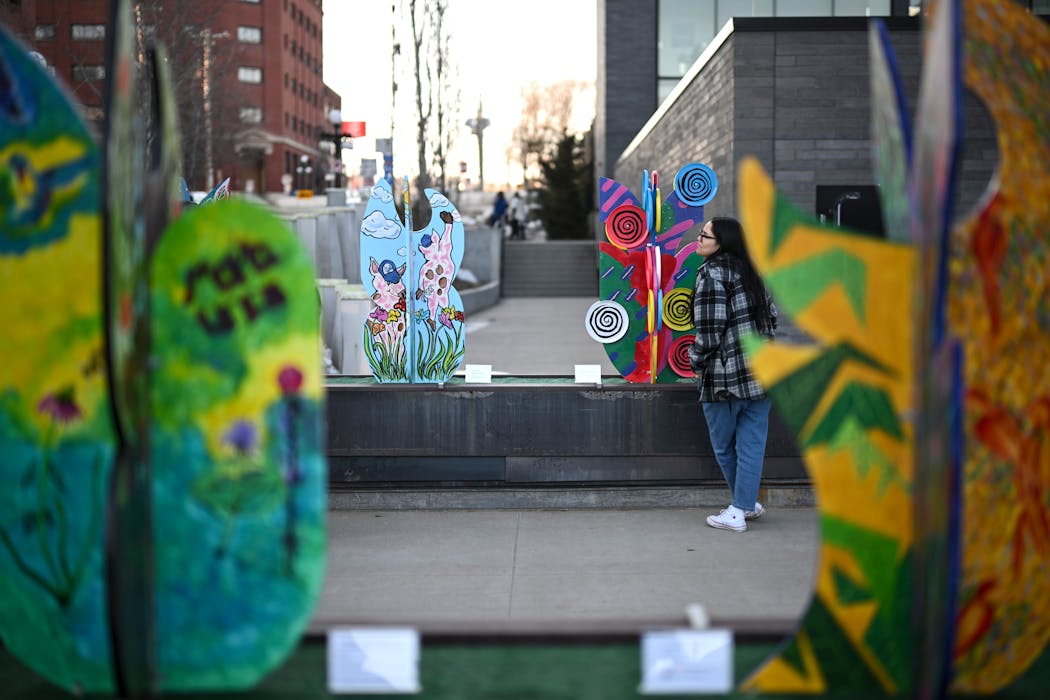 Shayla Tilsen-Lafferty, from the Pine Ridge Indian Reservation, checks out the “FAUX BLOOM ’23” public art project.
