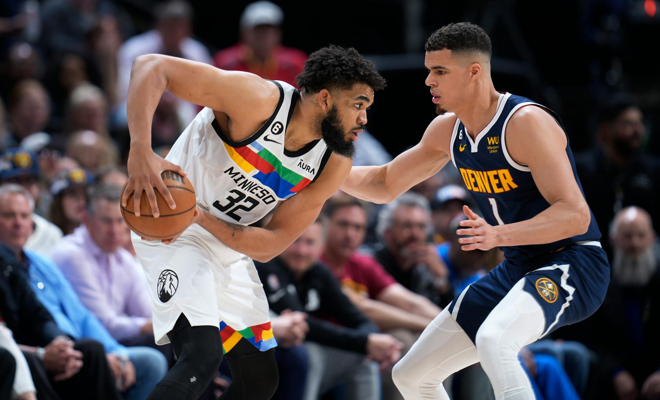 Minnesota Timberwolves center Karl-Anthony Towns, left, looks to pass the ball as Denver Nuggets forward Michael Porter Jr. defends during the second half.