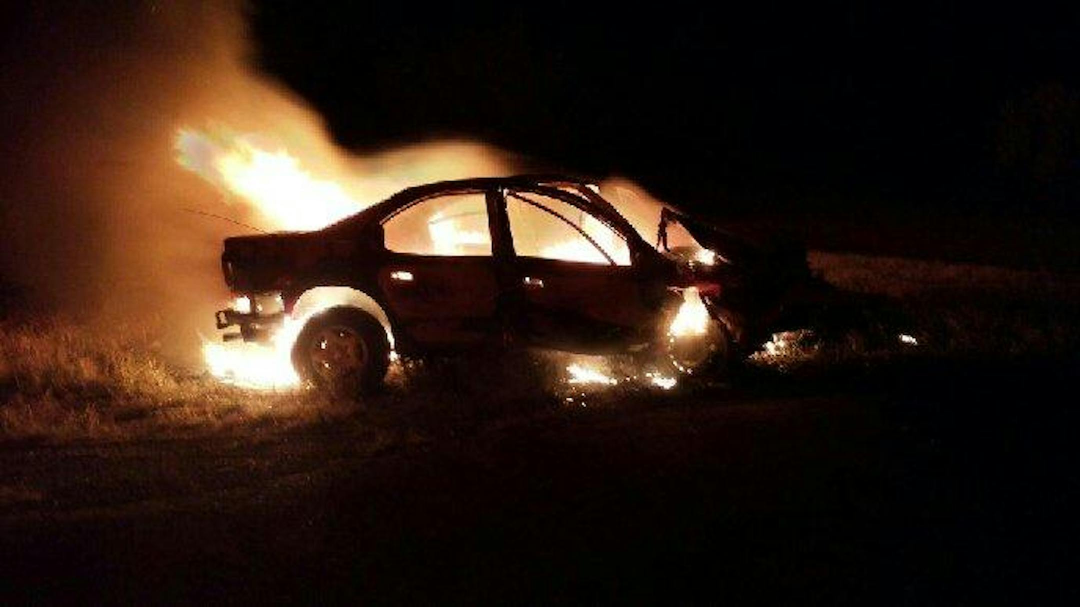 Tracy Ludwig's burning car, north of Grand Forks, on Sunday night.