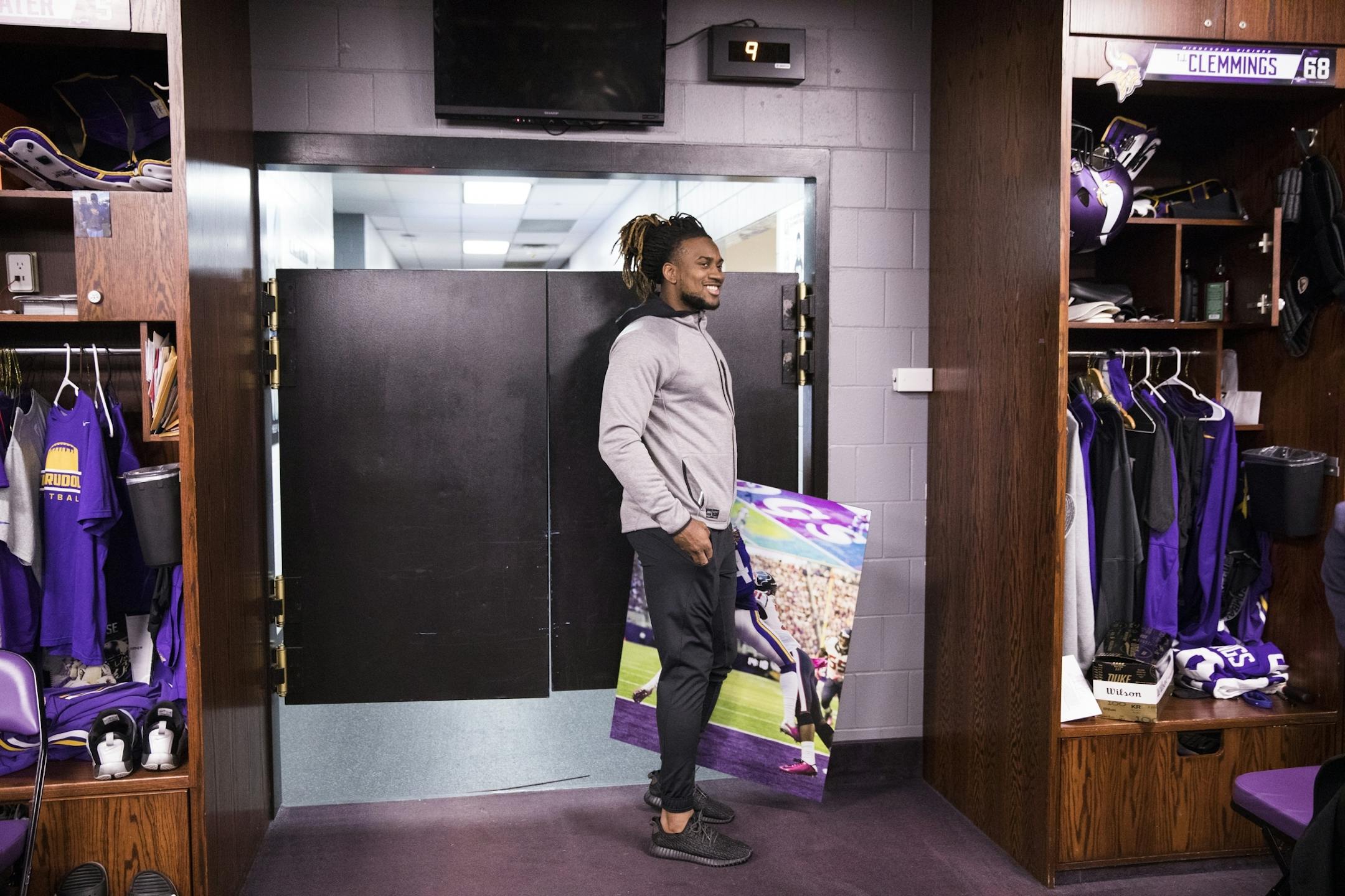 Cordarrelle Patterson leaves the locker room holding a photo of himself.