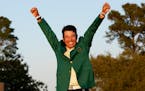 Hideki Matsuyama, of Japan, celebrates after putting on the champion's green jacket after winning the Masters golf tournament on Sunday, April 11, 202