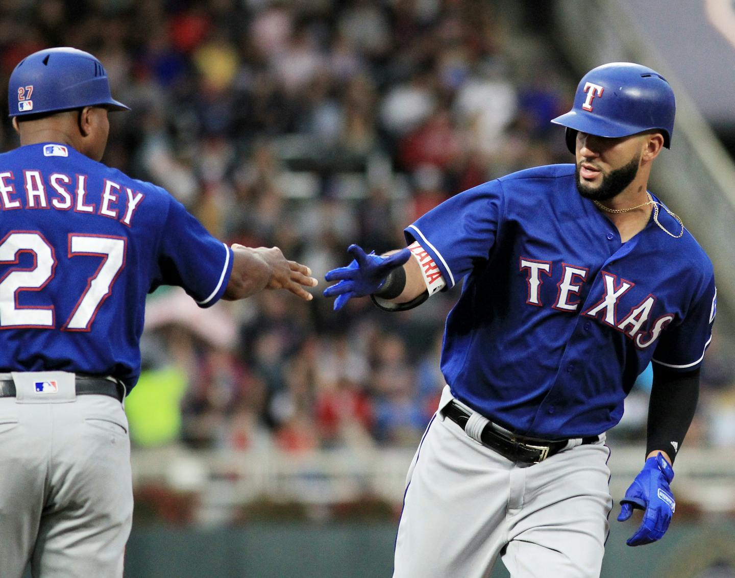 Texas Rangers' Nomar Mazara, right, is congratulated by third base coach Tony Beasley (27) after hitting a two-run home run against the Minnesota Twins in the first inning during a baseball game on Saturday, Aug. 5, 2017, in Minneapolis. (AP Photo/Andy Clayton-King)