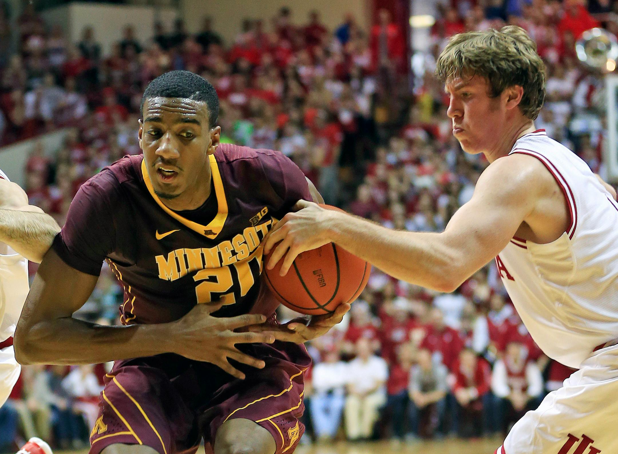 Indiana's Jordan Hulls (1) knocked the ball away from the Gophers' Austin Hollins (20) by during the first half Saturday in Bloomington, Ind.