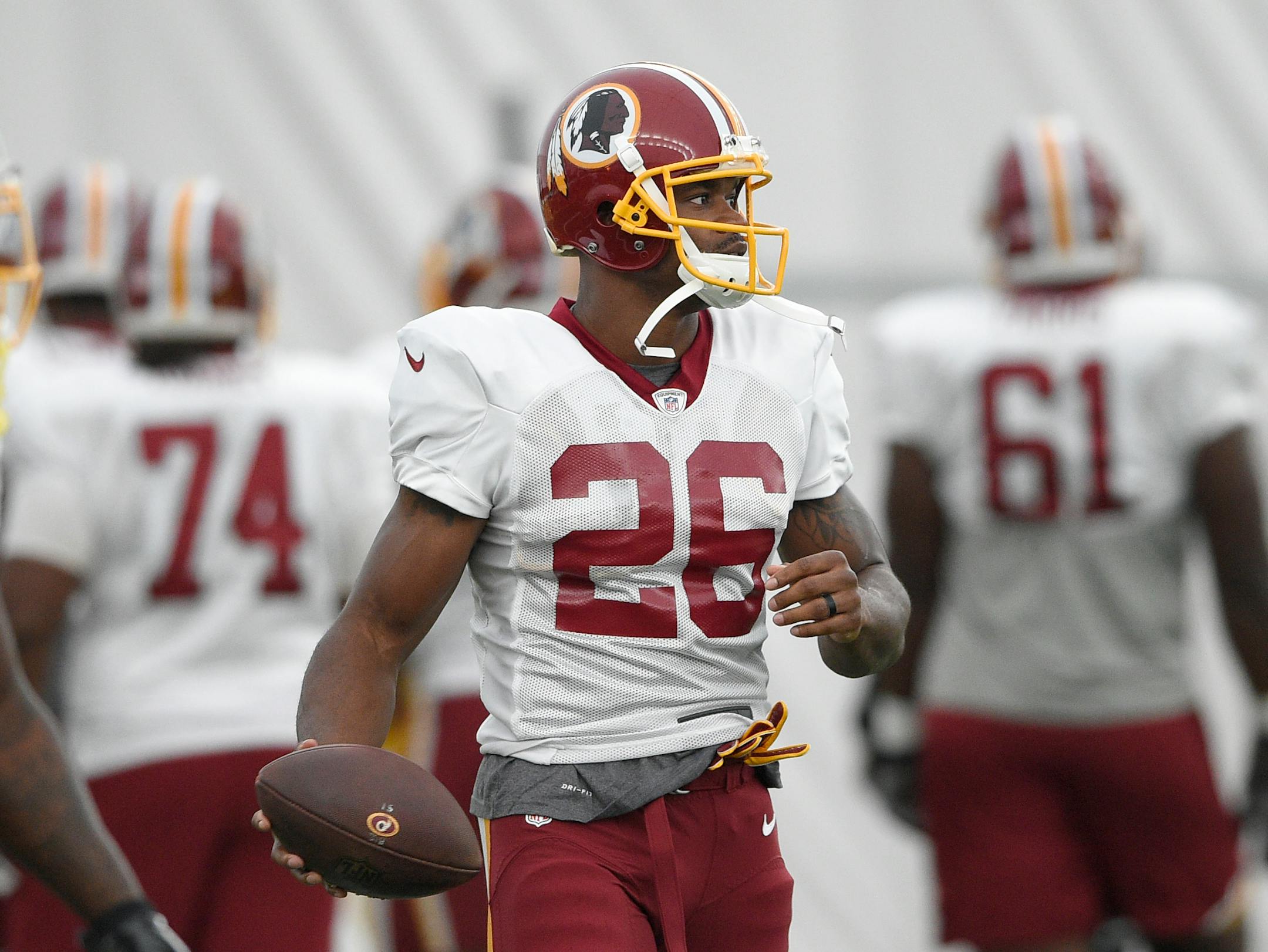 Washington Redskins running back Adrian Peterson holds the ball during an NFL football team practice, Tuesday, Aug. 21, 2018, in Ashburn, Va. (AP Photo/Nick Wass)