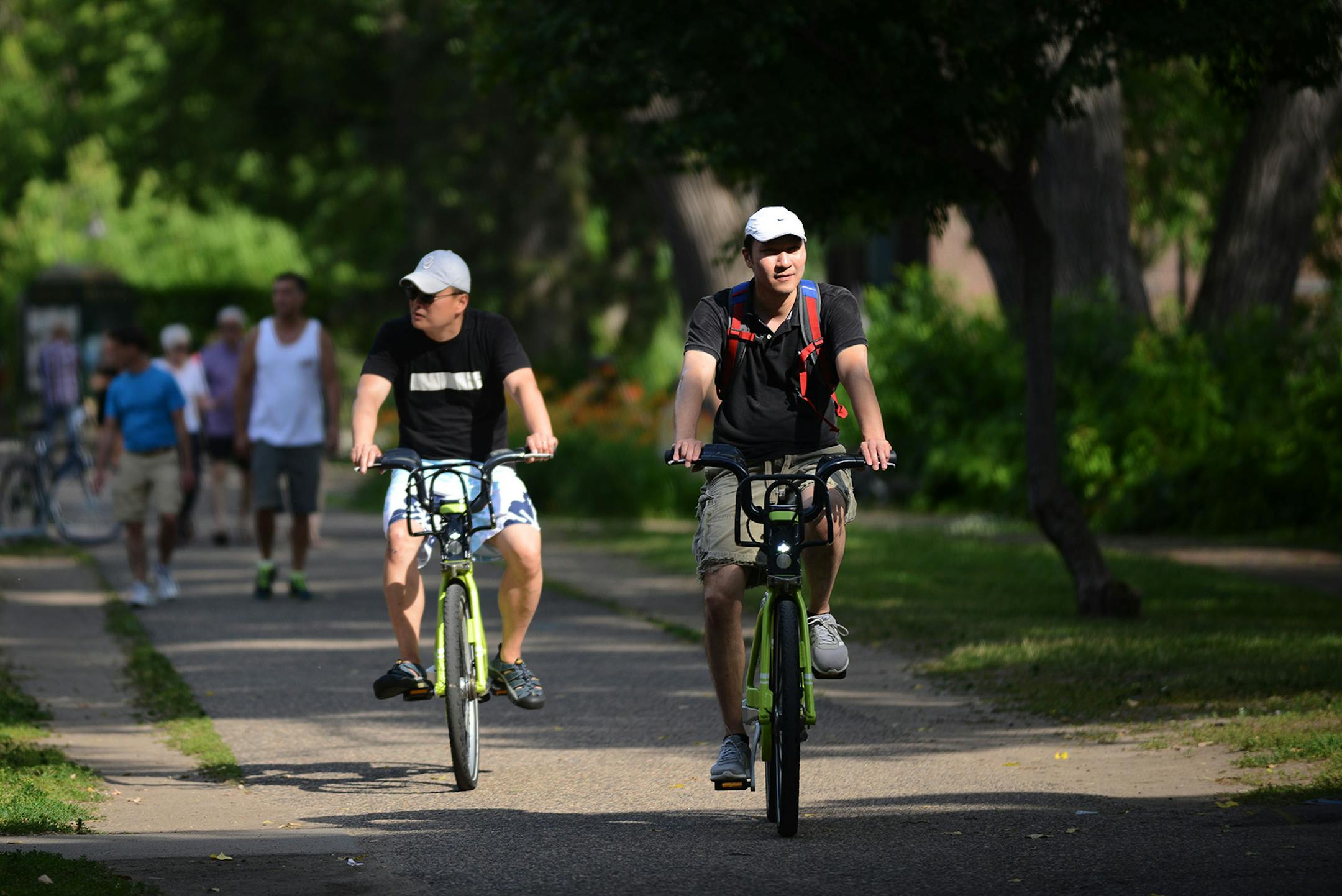 From left, Y.K. Cheong, of Washington, and Ken Tan, of Minneapolis, biked on SE. Main Street near St. Anthony Main in Minneapolis in June 2015.