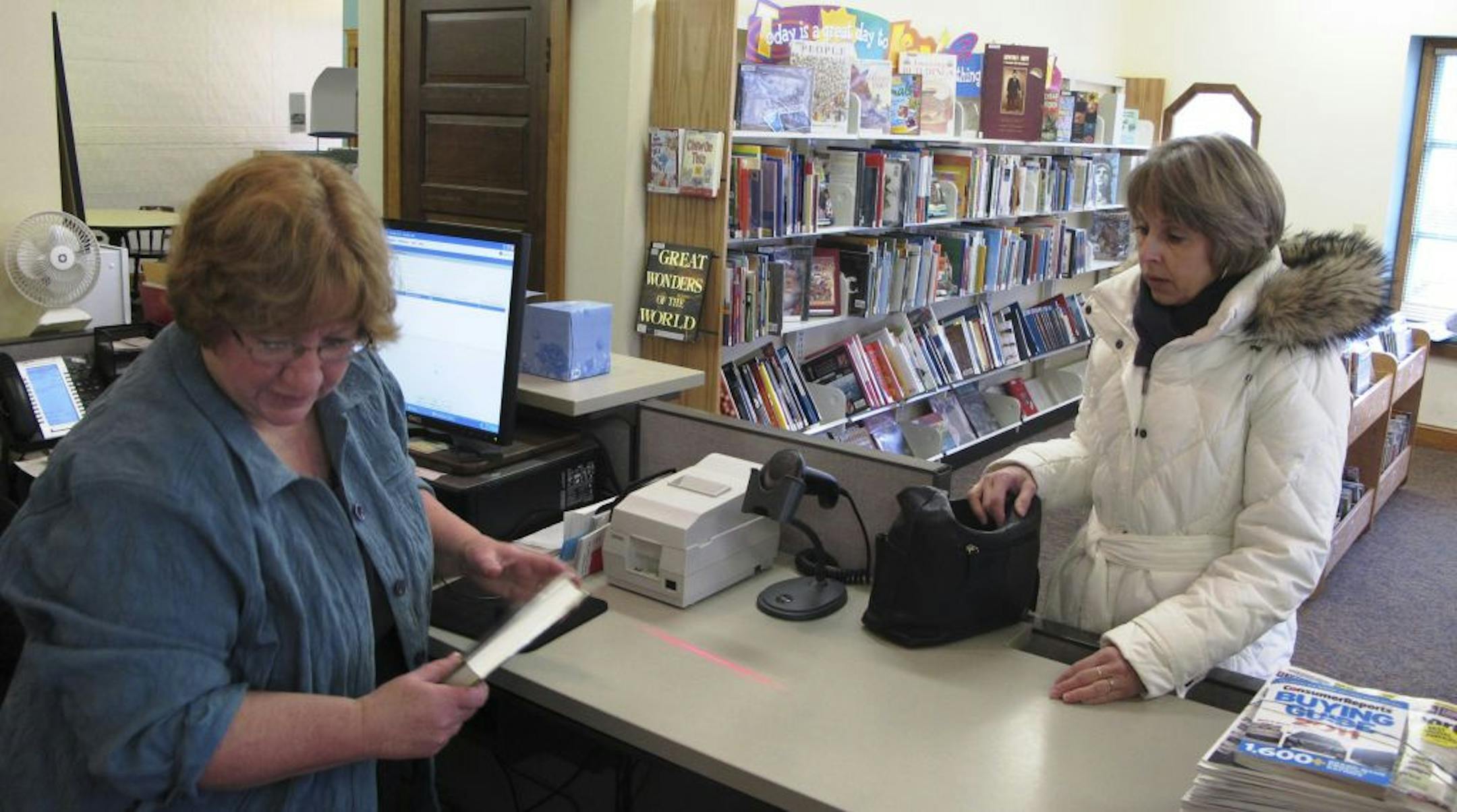 Star Tribune photo Tim Harlow With the help of librarian Martha Riel, Rhonda Place was one of the last patrons on Friday to check out a book at the Rosalie Wahl Library in Lake Elmo.