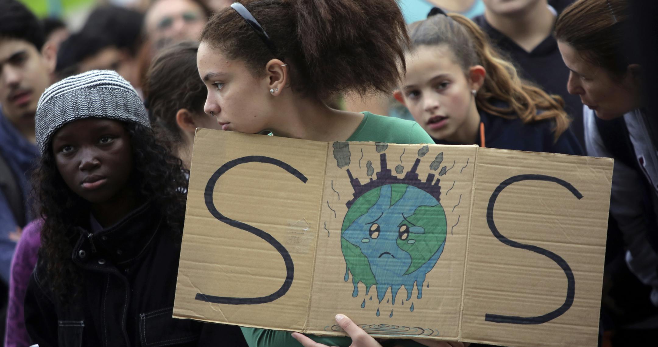 A young demonstrator holds a sign outside the Portuguese parliament in Lisbon during a worldwide protest demanding action on climate change, Friday, Nov. 29, 2019. Students worldwide are skipping class Friday to take to the streets to protest their governments' failure to take sufficient action against global warming. (AP Photo/Armando Franca)