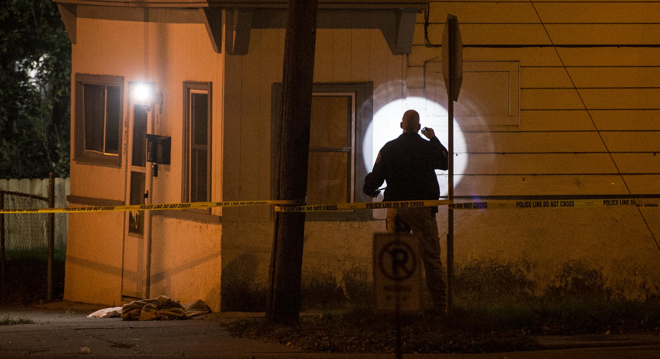 An Investigator used his flashlight to look for evidence near the scene of the fatal shooting of Sarah Wierstad at Beaumont Street East and Bedford Street in St. Paul Sunday night. ] (AARON LAVINSKY/STAR TRIBUNE) aaron.lavinsky@startribune.com St. Paul Police investigated a fatal shooting at Beaumont Street East and Bedford Street Sunday night in St. Paul.