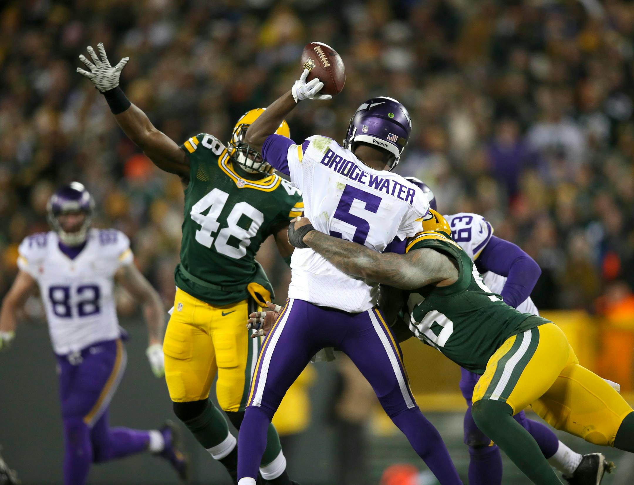 Vikings quarterback Teddy Bridgewater (5) was pressured by Packers linebacker Joe Thomas (48) and Packers outside linebacker Mike Neal (96) in the third quarter Sunday night.