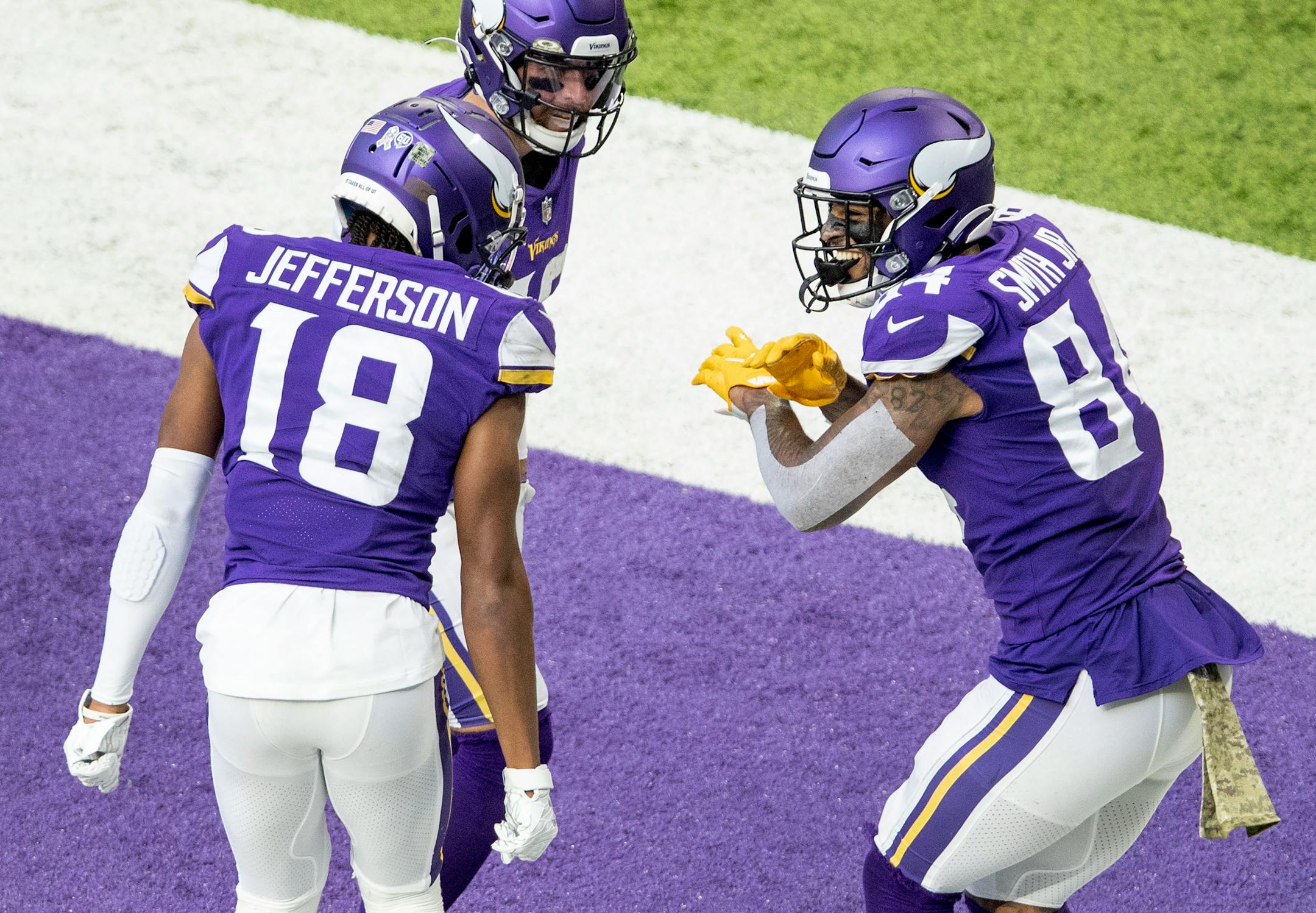 Minnesota Vikings tight end Irv Smith Jr. (84) celebrated with teammates Justin Jefferson (18) and Adam Thielen (19) after scoring a touchdown in the third quarter.