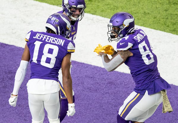 Minnesota Vikings tight end Irv Smith Jr. (84) celebrated with teammates Justin Jefferson (18) and Adam Thielen (19) after scoring a touchdown in the 