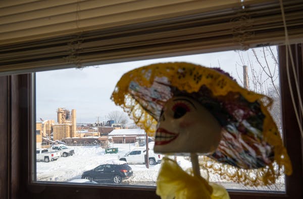 An industrial site including Smith Foundry Co. and Bituminous Roadways can be seen through a window at Circulo de Amigos Child Care Center in Minneapo