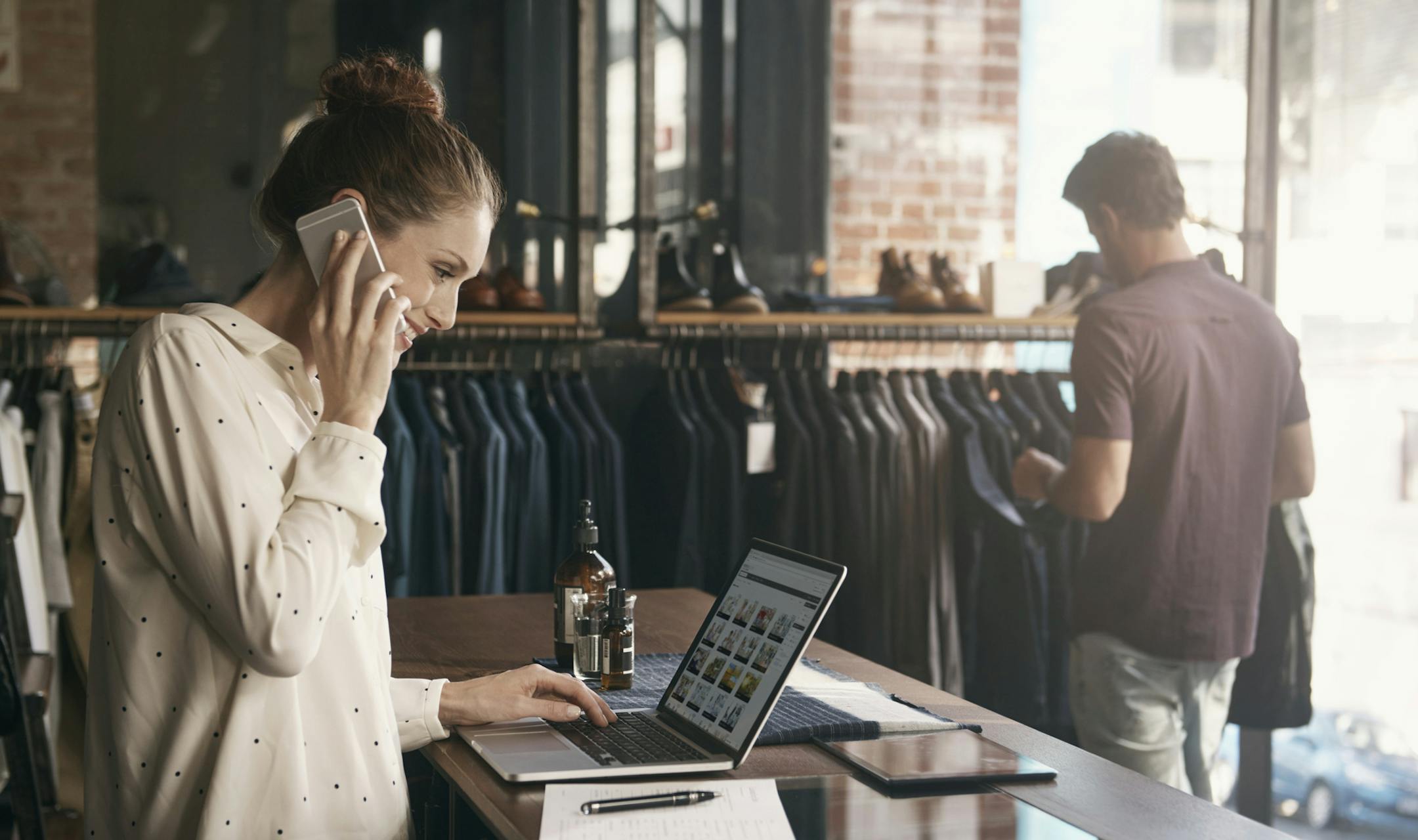 A young woman in front of her clothing boutique. istock photo