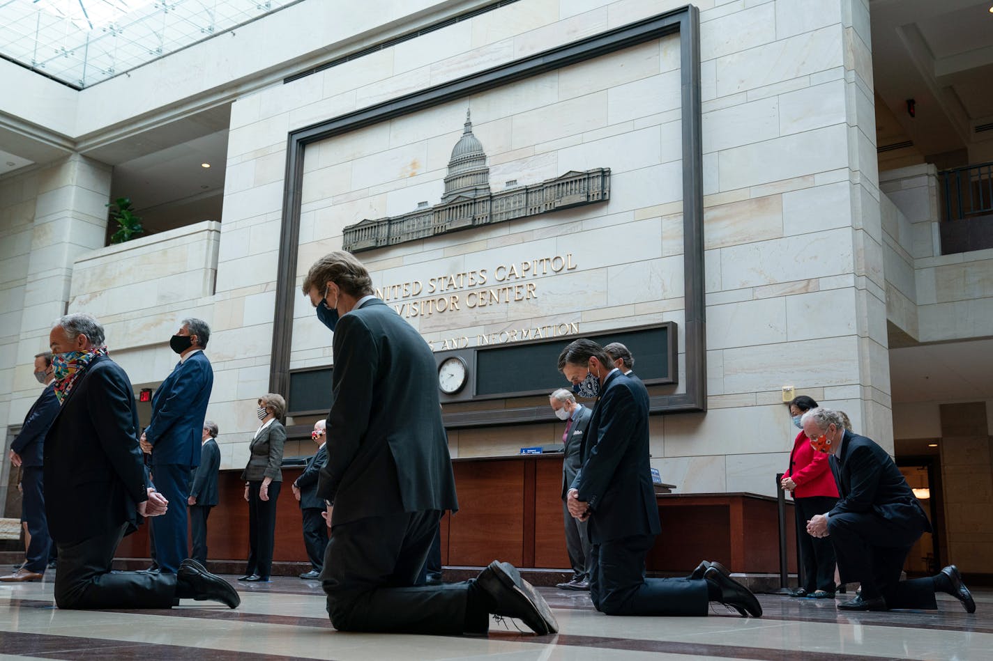 From left: Sens. Tim Kaine (D-Va.), Michael Bennet (D-Colo.), Martin Heinrich (D-N.M.), and Chris Van Hollen (D-Md.), kneel as Democratic Caucus members participate in a moment of silence in Emancipation Hall at the Capitol in Washington, Thursday, June 4, 2020, to commemorate the lives of of George Floyd, Ahmaud Arbery, and Breonna Taylor, and to stand in solidarity with Americans throughout the country protesting racial injustice. Hundreds are expected to attend a memorial service for Floyd in