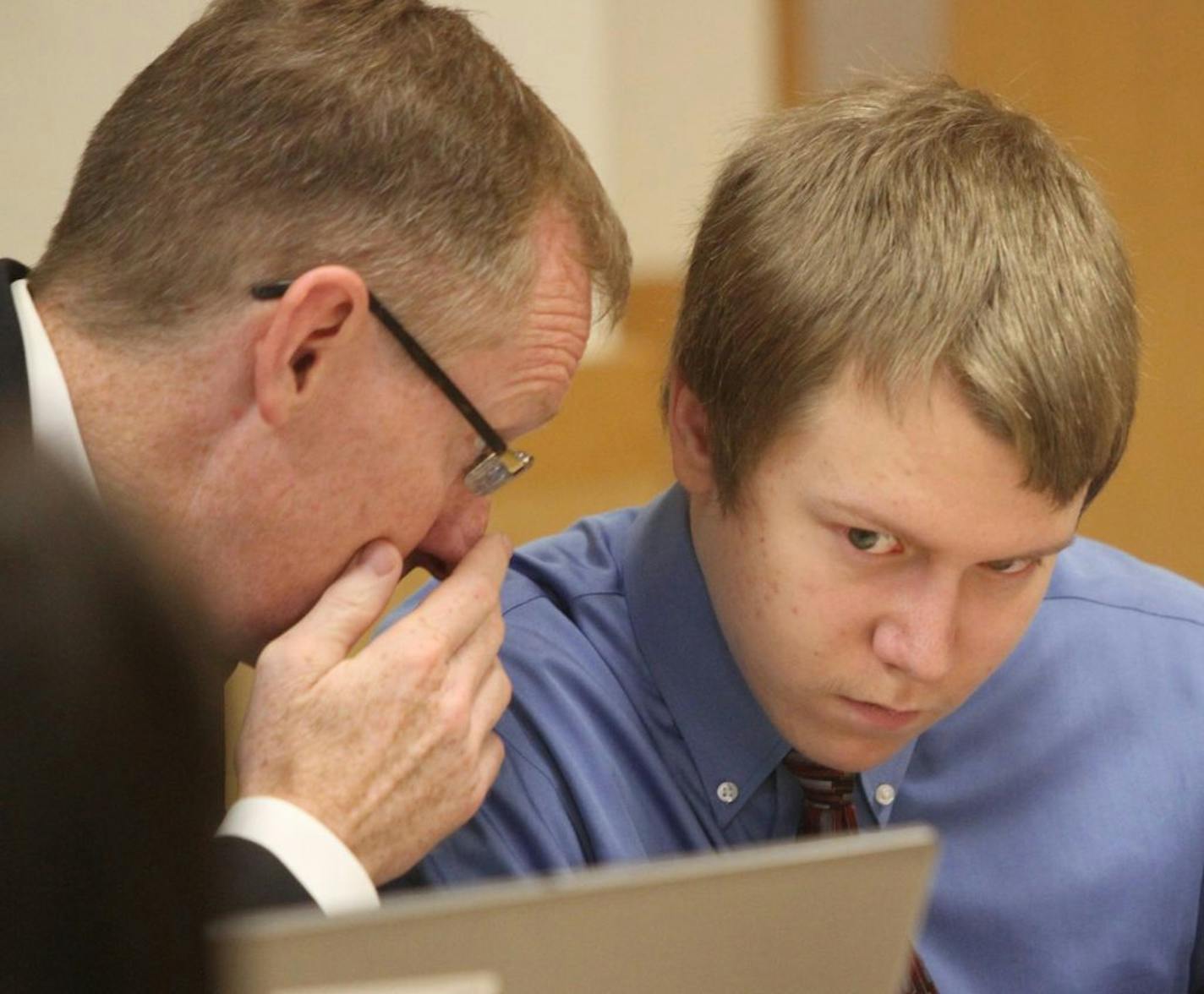 Michael Swanson, right, conferred with defense attorney Joe McCarville during his first-degree murder trial Wednesday in Carroll, Iowa.