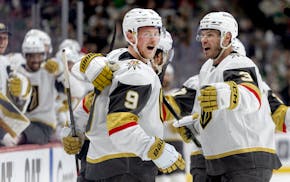 Jack Eichel (9), Brayden McNabb (3) and Vegas Golden Knights teammates celebrate a goal by Eichel against the Wild in the second period at Xcel Energy