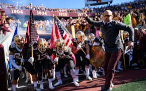Minnesota Gophers head coach PJ Fleck leads the team onto the field before the start of a football game between the University of Minnesota Gophers an
