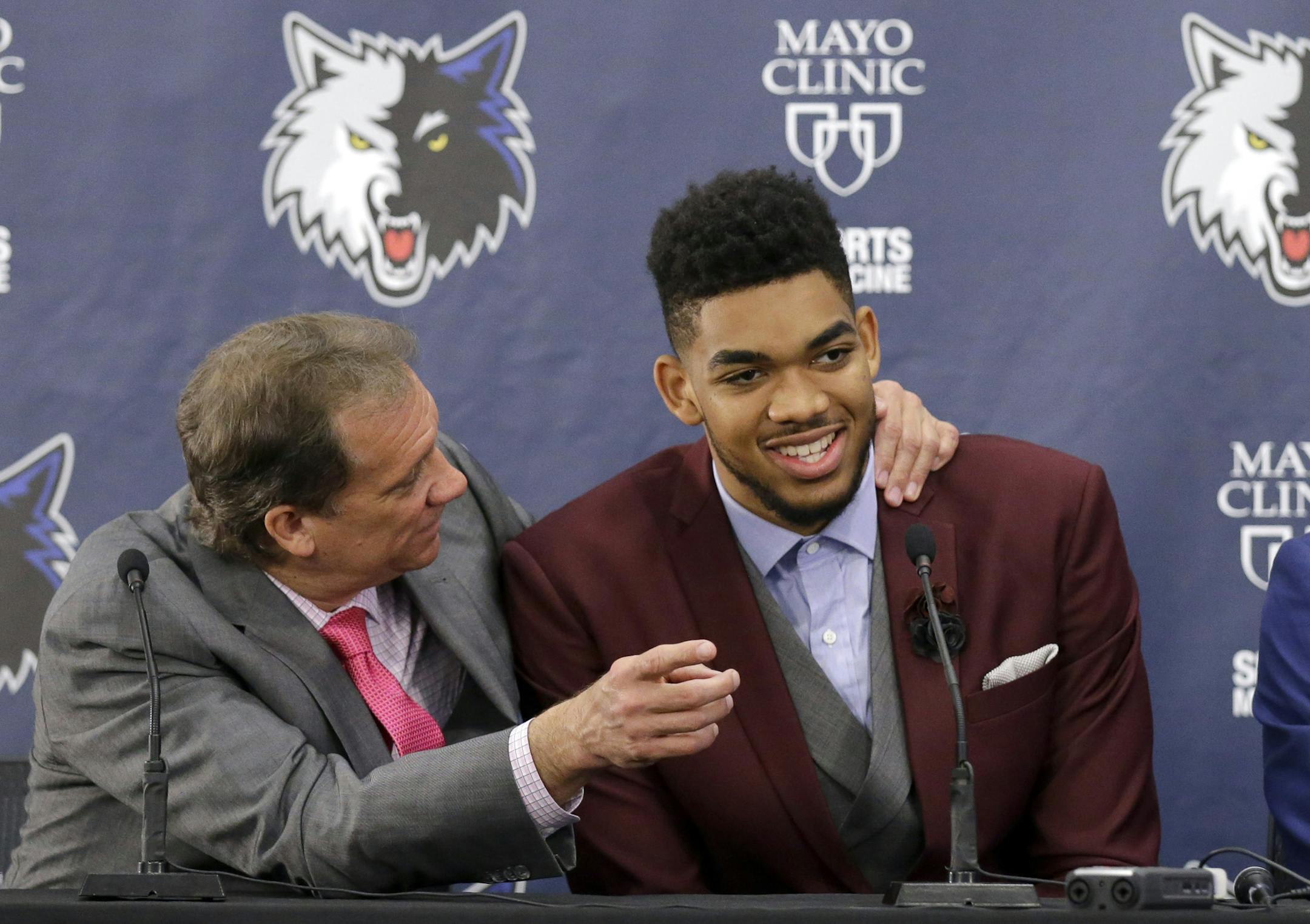 FILE - In this June 26, 2015, file photo, Minnesota Timberwolves' Karl-Anthony Towns, right, the No. 1 overall pick in the NBA draft, shares a laugh with head coach Flip Saunders during an NBA basketball news conference in Minneapolis. Towns has put together a historic rookie season that has him steamrolling toward the Rookie of the Year award. Before it all began, he had to endure the grief of losing NBA legend Darrell Dawkins, who Towns called Uncle Darrell, and Saunders, the coach who picked
