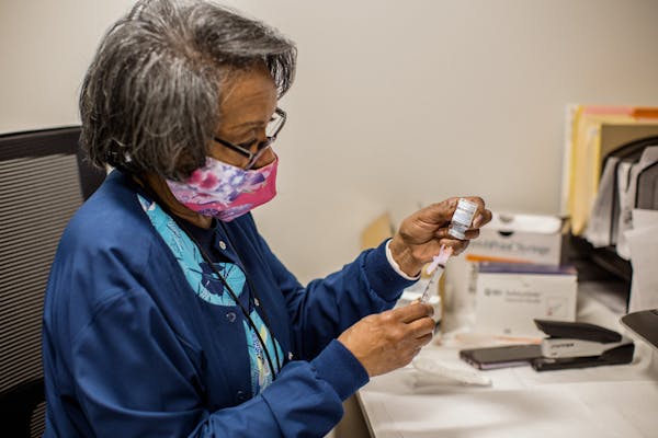 A nurse supervisor prepared a COVID booster shot at a city health department site in Baltimore, Oct. 4, 2022. 
