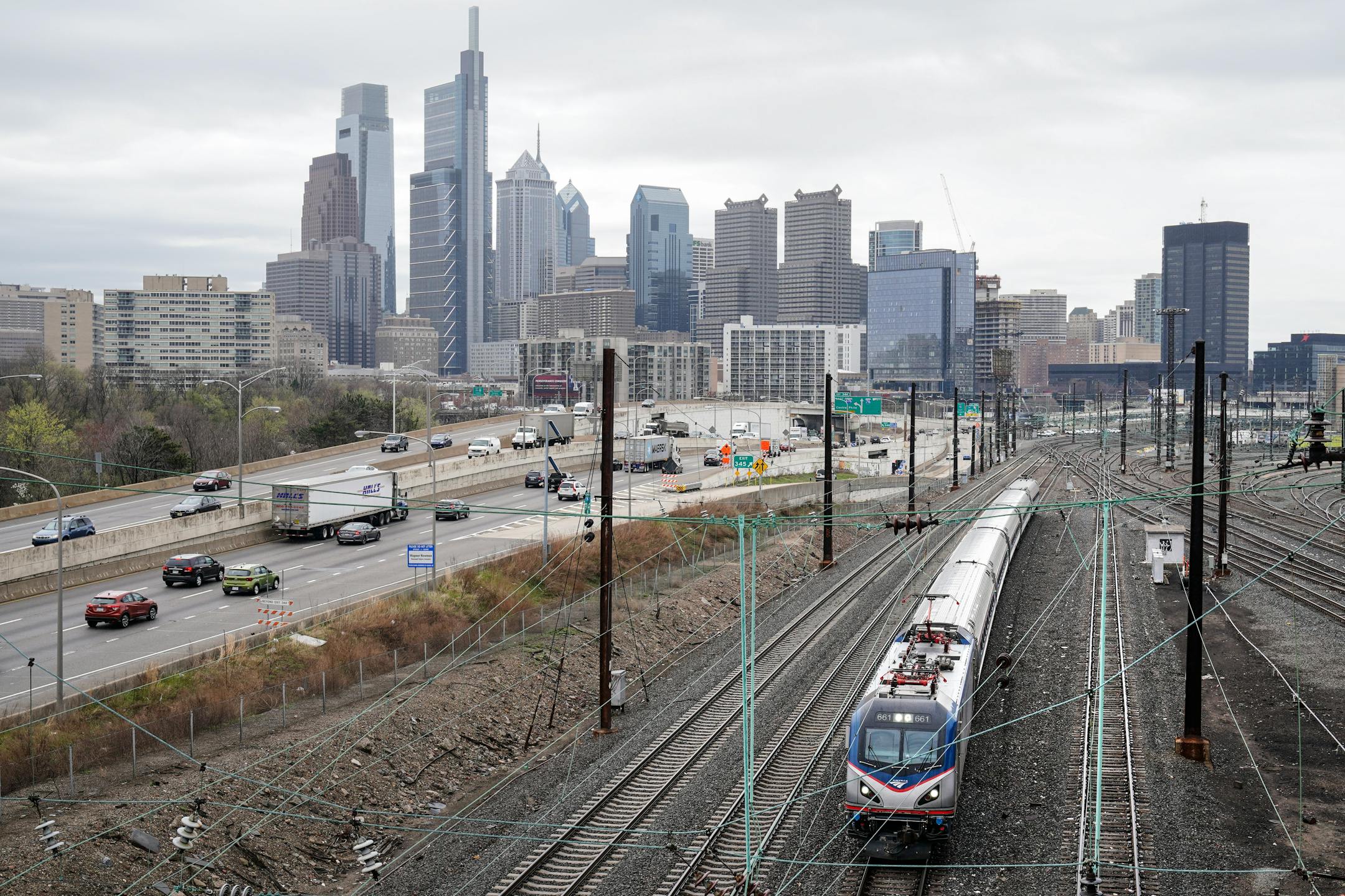 An Amtrak train departs 30th Street Station moving parallel to motor vehicle traffic on Interstate 76 in Philadelphia, Wednesday, March 31, 2021. Looking beyond the $1.9 trillion COVID relief bill, President Joe Biden and lawmakers are laying the groundwork for another of his top legislative priorities — a long-sought boost to the nation's roads, bridges and other infrastructure that could meet GOP resistance to a hefty price tag. (AP Photo/Matt Rourke)