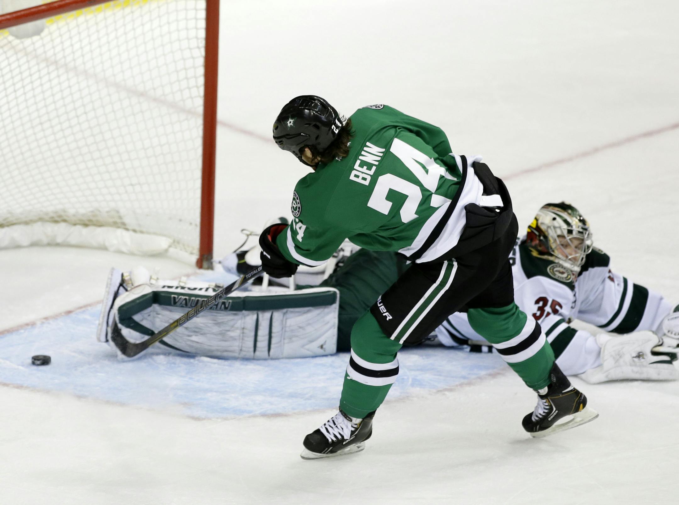 Dallas Stars defenseman Jordie Benn (24) scores on a penalty shot against Minnesota Wild's Darcy Kuemper (35) in the third period of an NHL hockey game, Tuesday, Jan. 21, 2014, in Dallas. The Stars won 4-0. (AP Photo/Tony Gutierrez)