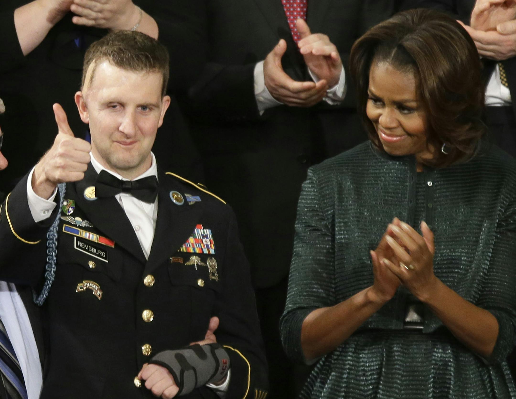 Army Ranger Sgt.1st Class Cory Remsburg acknowledges applause from first lady Michelle Obama and others during President Barack Obama's State of the Union address on Capitol Hill in Washington, Tuesday Jan. 28, 2014. (AP Photo/J. Scott Applewhite) ORG XMIT: MIN2014012822425244
