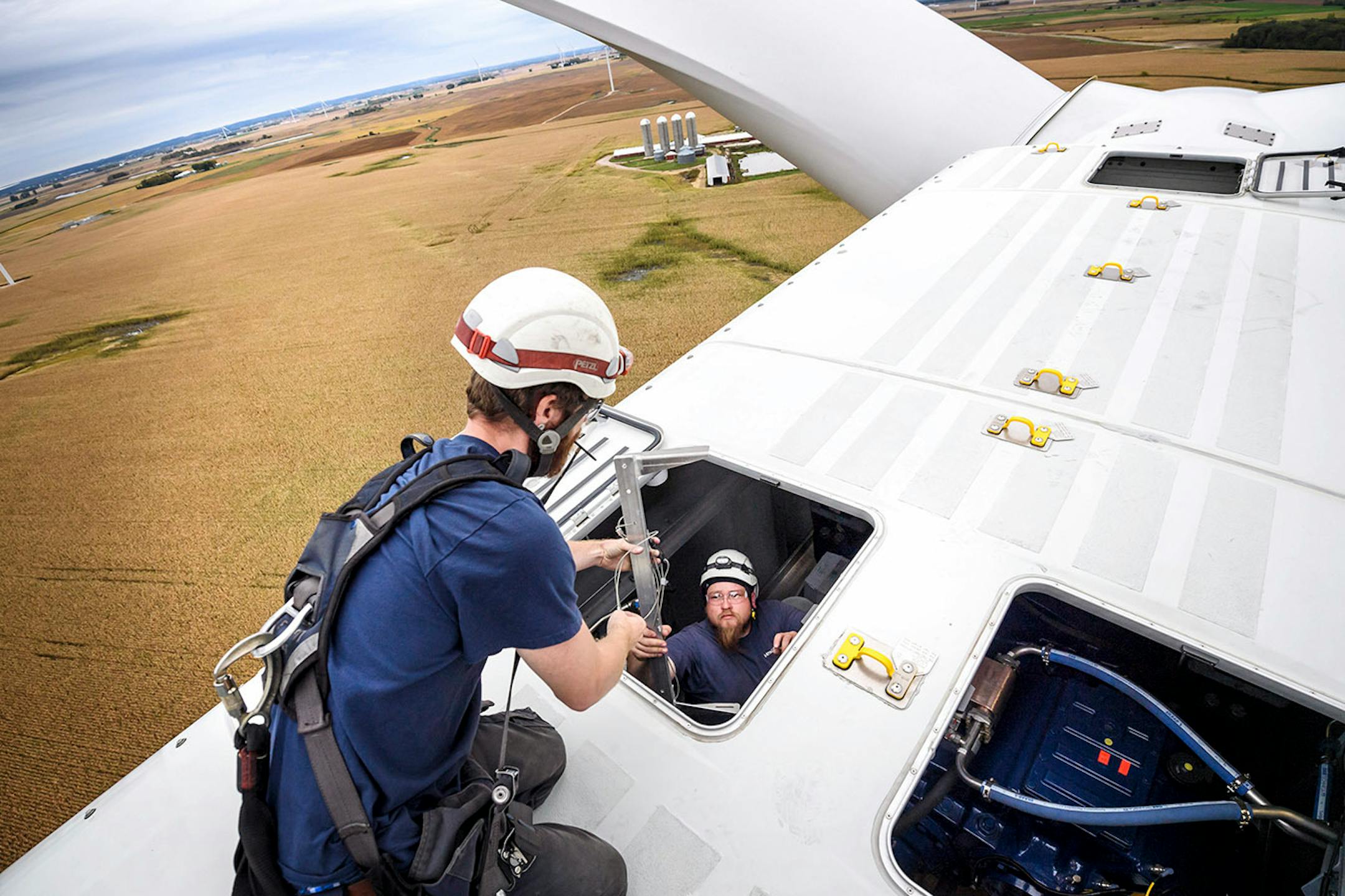 Chris Berg handed an alignment tool up to Shane Keck on top of the nacelle.