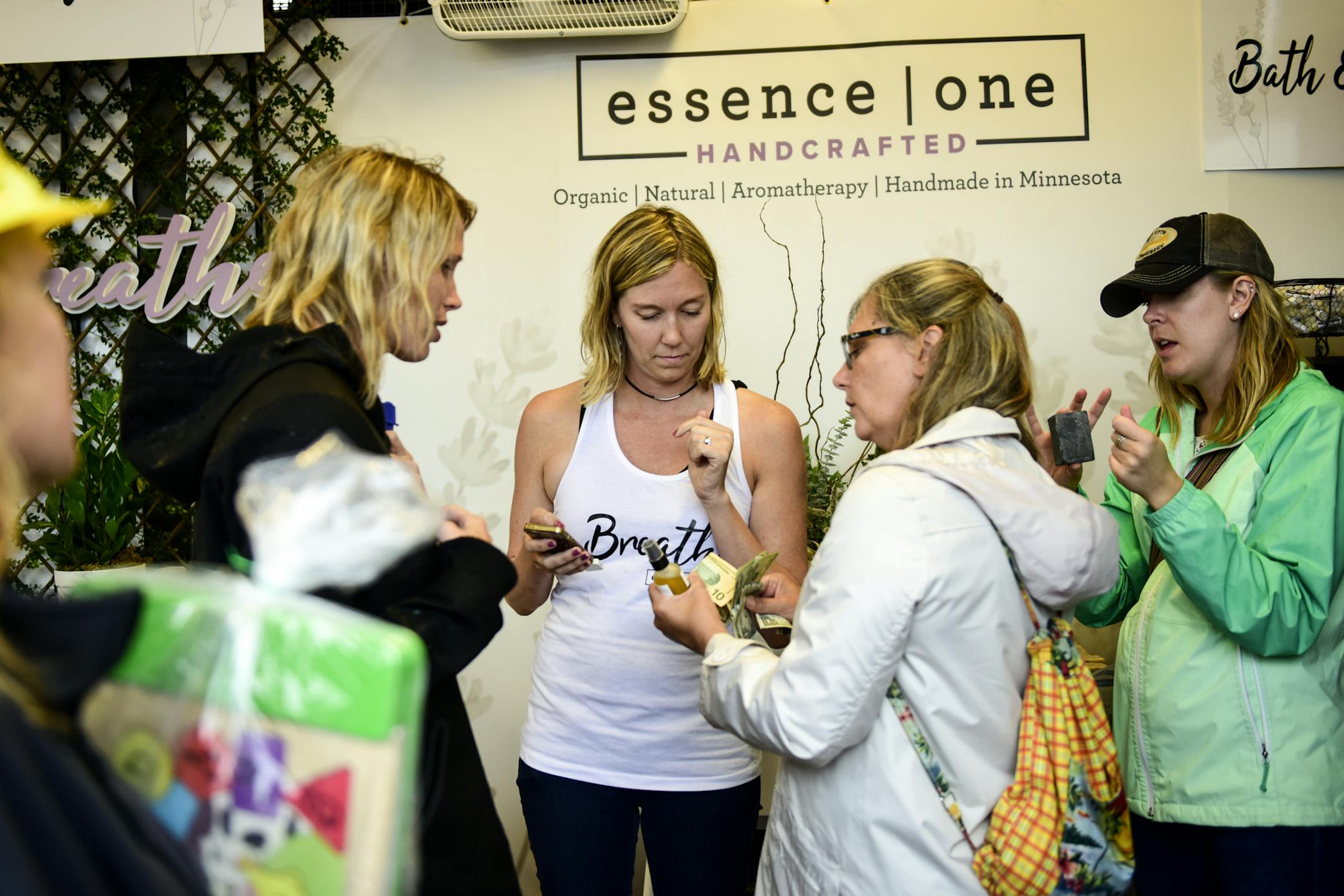 Essence One owner, Lauren VanScoy, center, helped customers at her shop at the Minnesota State Fair.