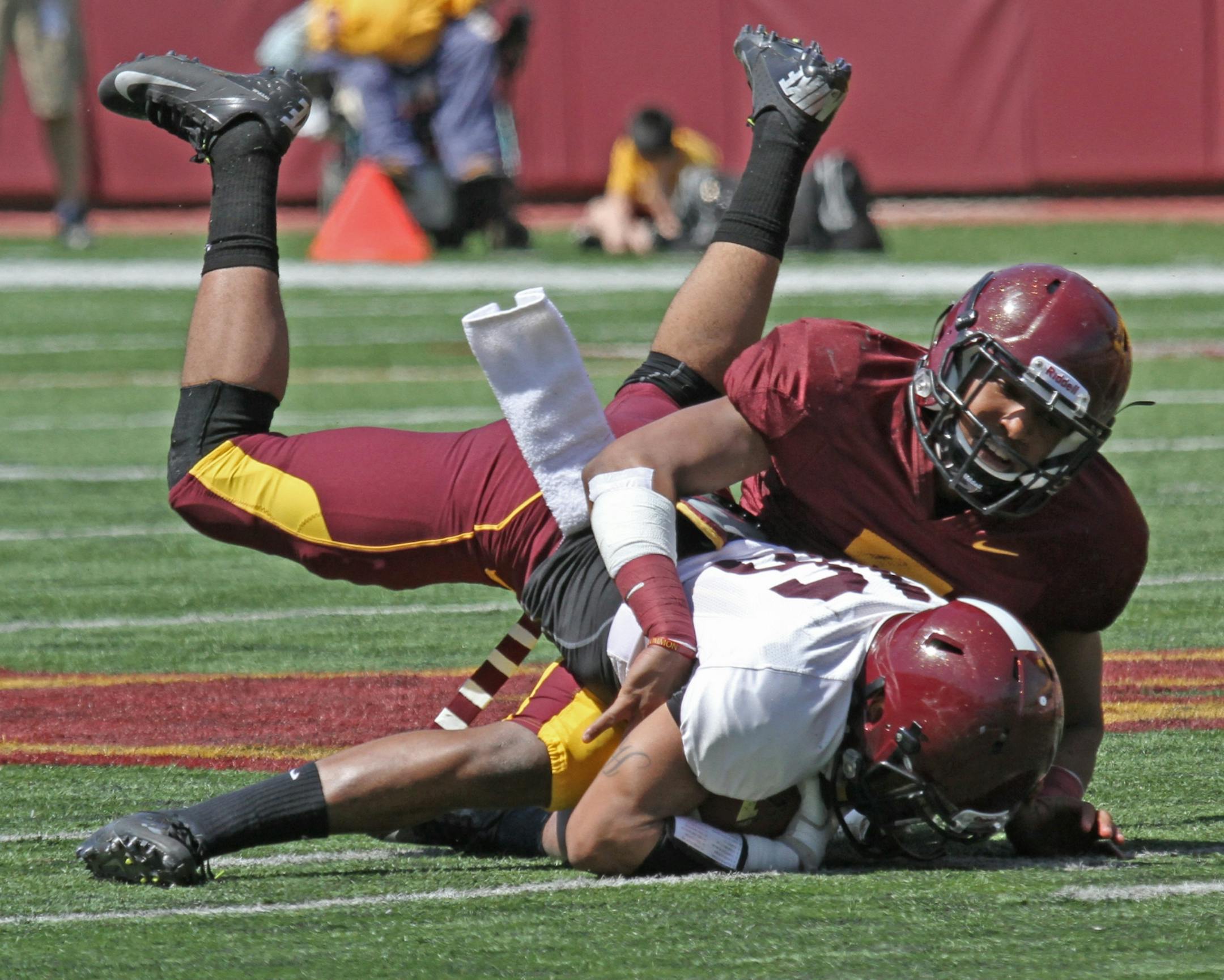 Maroon team defensive back Damarius Travis took down Gophers White wide receiver Jamel Harbison during the spring game at TCF Stadium on 4/27/13.