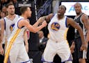Golden State Warriors forward Draymond Green (23) reacted to a foul call as Warriors guard Stephen Curry talked to him during the first half of Sunday