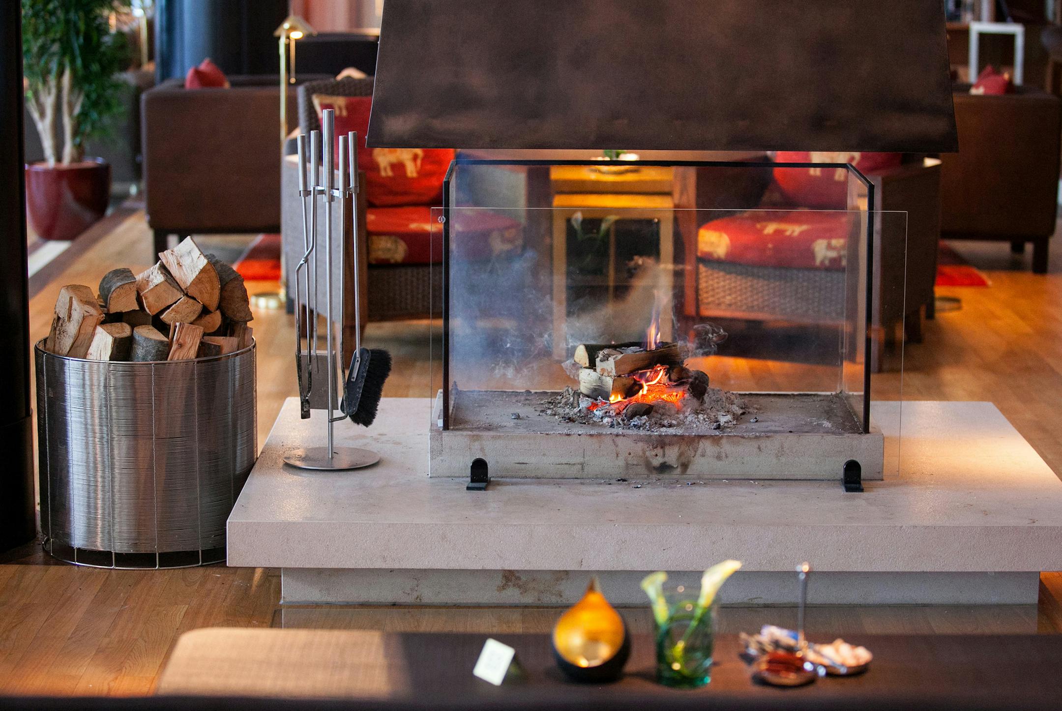 A log fire burns in the guest lounge of the Schloss Elmau hotel; the unique resort - composed of a 162-room, family-friendly hotel, a 47-suite retreat, and six spas - is the ultimate digital detox. MUST CREDIT: Bloomberg photo by Krisztian Bocsi.