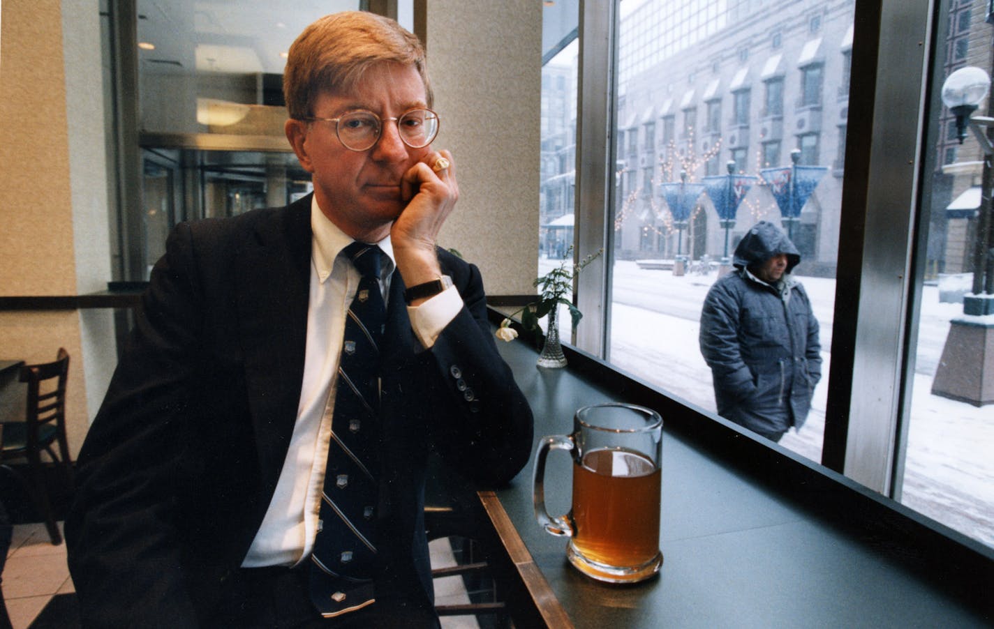 Columnist and author George F. Will sits at the counter of the Nicollet Mall (Minneapolis) Barnes & Noble bookstore having hot tea, trying to regain his lost voice. Will was not well and had lost his voice. Star Tribune photo, December 8, 1994, by Rita Reed.