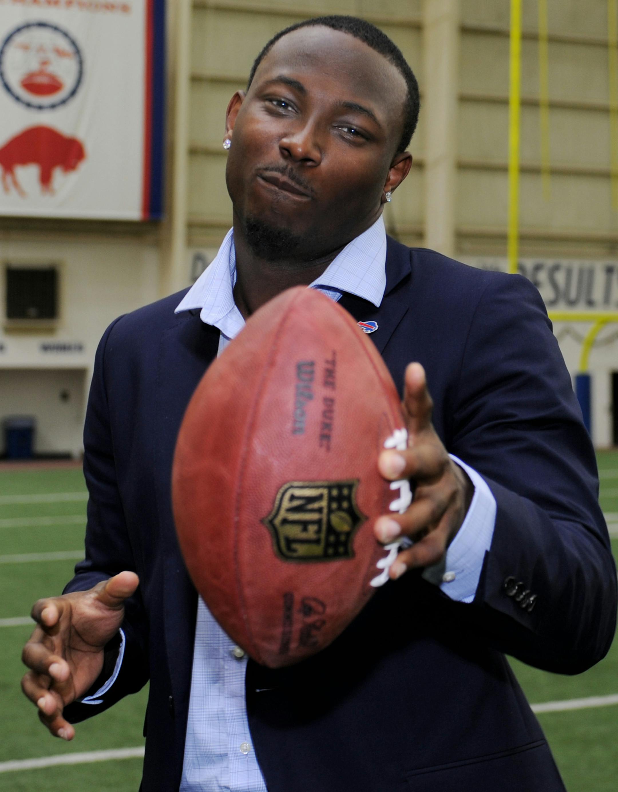 Buffalo Bills running back LeSean McCoy gestures with a football in Orchard Park, N.Y., Tuesday, March 10, 2015. McCoy says he's happy to be someplace where he feels appreciated. He's excited to be on a Rex Ryan-coached team that will make it a priority run the ball. And the NFL's 2013 rushing leader is pleased to have a restructured five-year contract that secures his long-term future. (AP Photo/Gary Wiepert) ORG XMIT: MIN2015041021370928