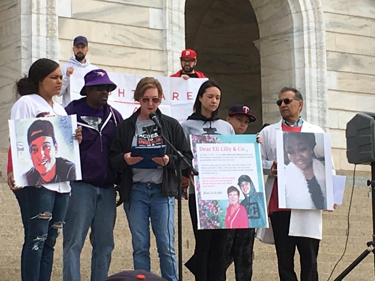 James Holt Jr. and Nicole Smith-Holt (third from right) rallied at the Minnesota state Capitol on Saturday against the high and rising prices of prescription drugs. Their 26-year-old son, Alec Smith, died last June just weeks after aging out of his parents' health insurance. Unable to afford coverage of his own, he had begun rationing diabetes medication because he couldn't pay for the $1,300 refill.