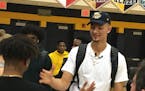Dawson Garcia, right, was congratulated by a friend moments after announcing Wednesday that he will play college basketball next year at Marquette.