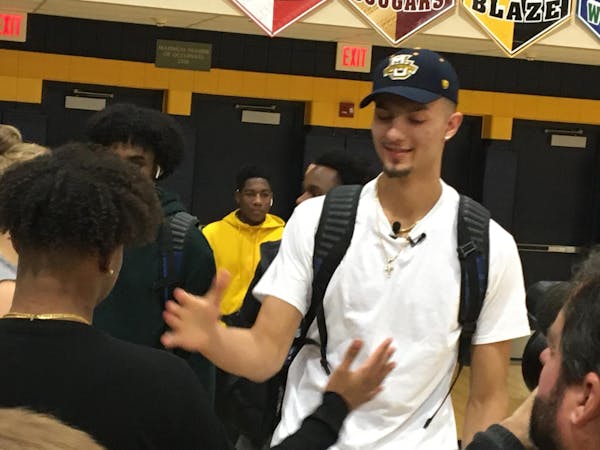 Dawson Garcia, right, was congratulated by a friend moments after announcing Wednesday that he will play college basketball next year at Marquette.
