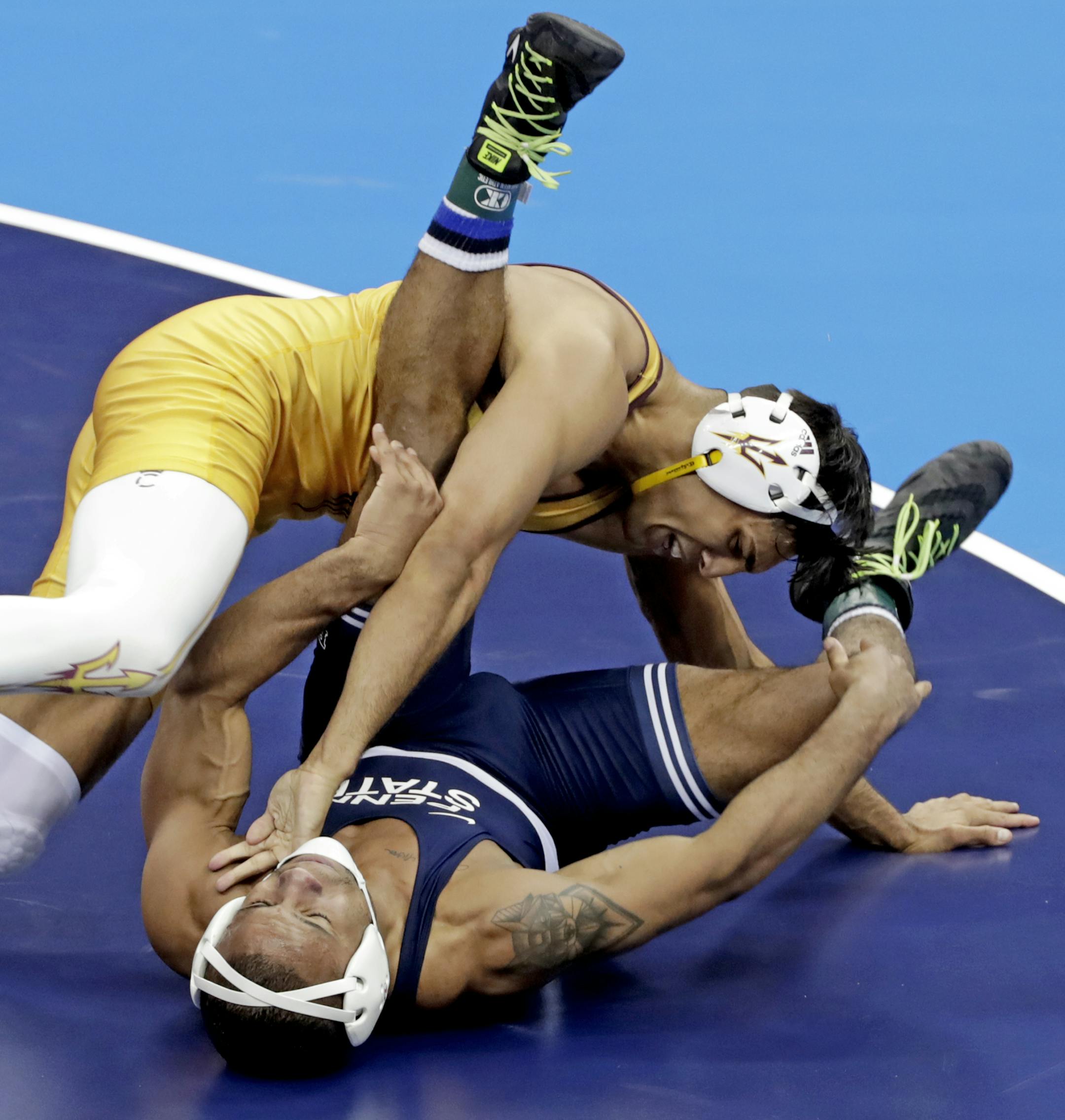 Penn State's Mark Hall, bottom, is taken down by Arizona State's Zahid Valencia in their 174-pound match in the finals of the NCAA wrestling championships Saturday, March 23, 2019 in Pittsburgh. Valencia won the match. (AP Photo/Gene J. Puskar)
