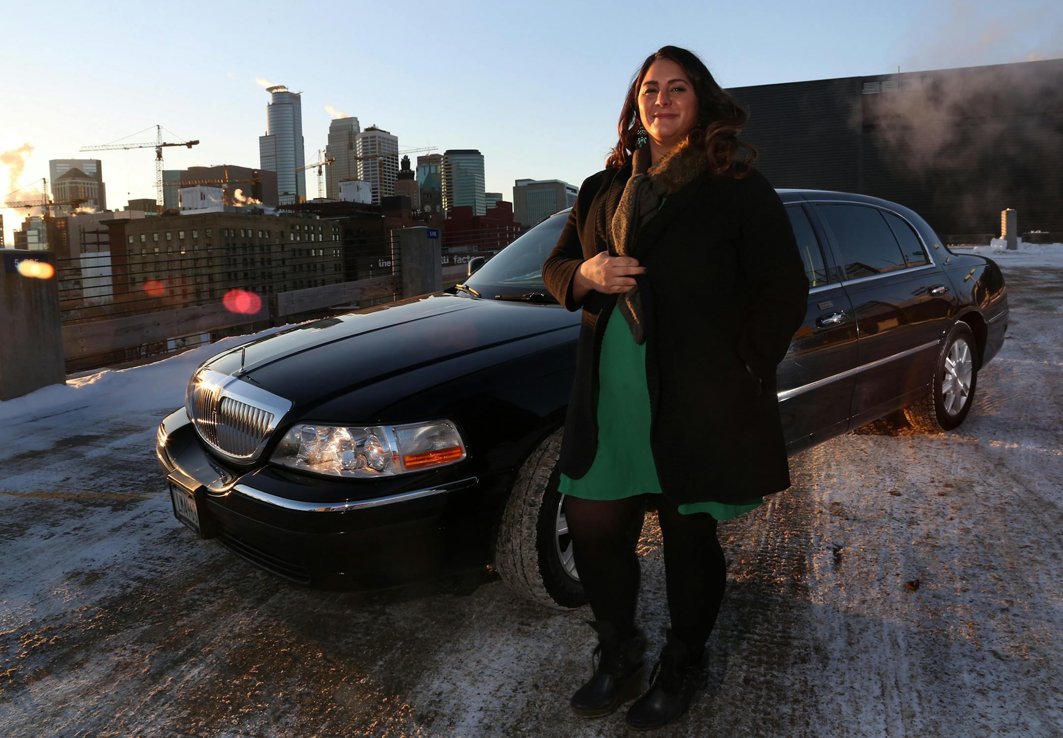 Chey Eisenman, owner of her own cab, stood next to her car on the roof of the parking ramp across the street from the Guthrie Theater. Eisenman is one of the few female cab drivers in the male-dominated industry. ] (KYNDELL HARKNESS/STAR TRIBUNE) kyndell.harkness@startribune.com On top of a parking ramp in Minneapolis Min., Thursday, January 8, 2014.