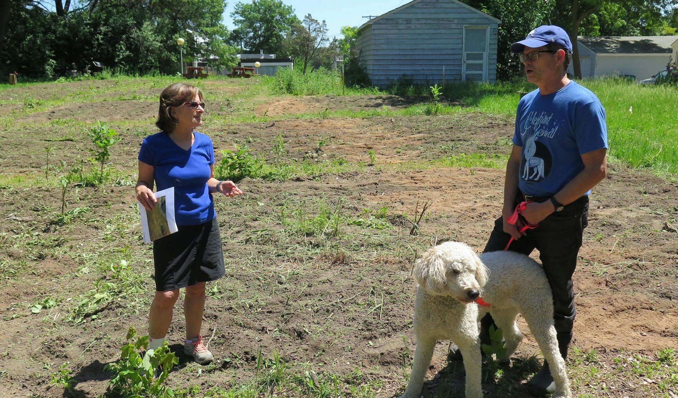 Sharon Lehrman and Fin Donesky, standing with his dog Rufus, speak in the Birchwood Gardens in St. Louis Park on Tuesday, June 6. City crews are tilling the soil and opening up the garden by this weekend.