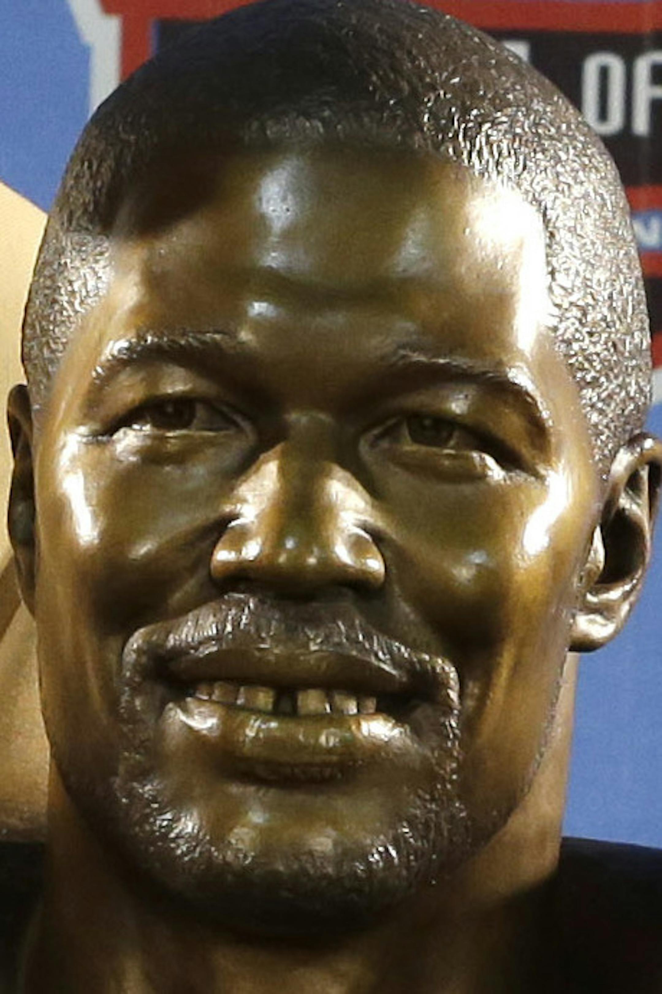 Hall of Fame inductee Michael Strahan, left, with presenter Jay Glazer pose with Strahan's bust during the Pro Football Hall of Fame enshrinement ceremony Saturday, Aug. 2, 2014, in Canton, Ohio. (AP Photo/Tony Dejak)