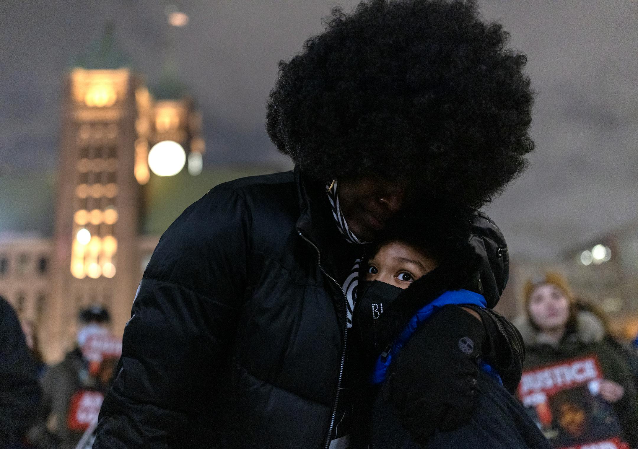 Pamela Weems hugs her grandson Rebel Smith, 9, during National Solidarity Justice for Amir Locke event.
